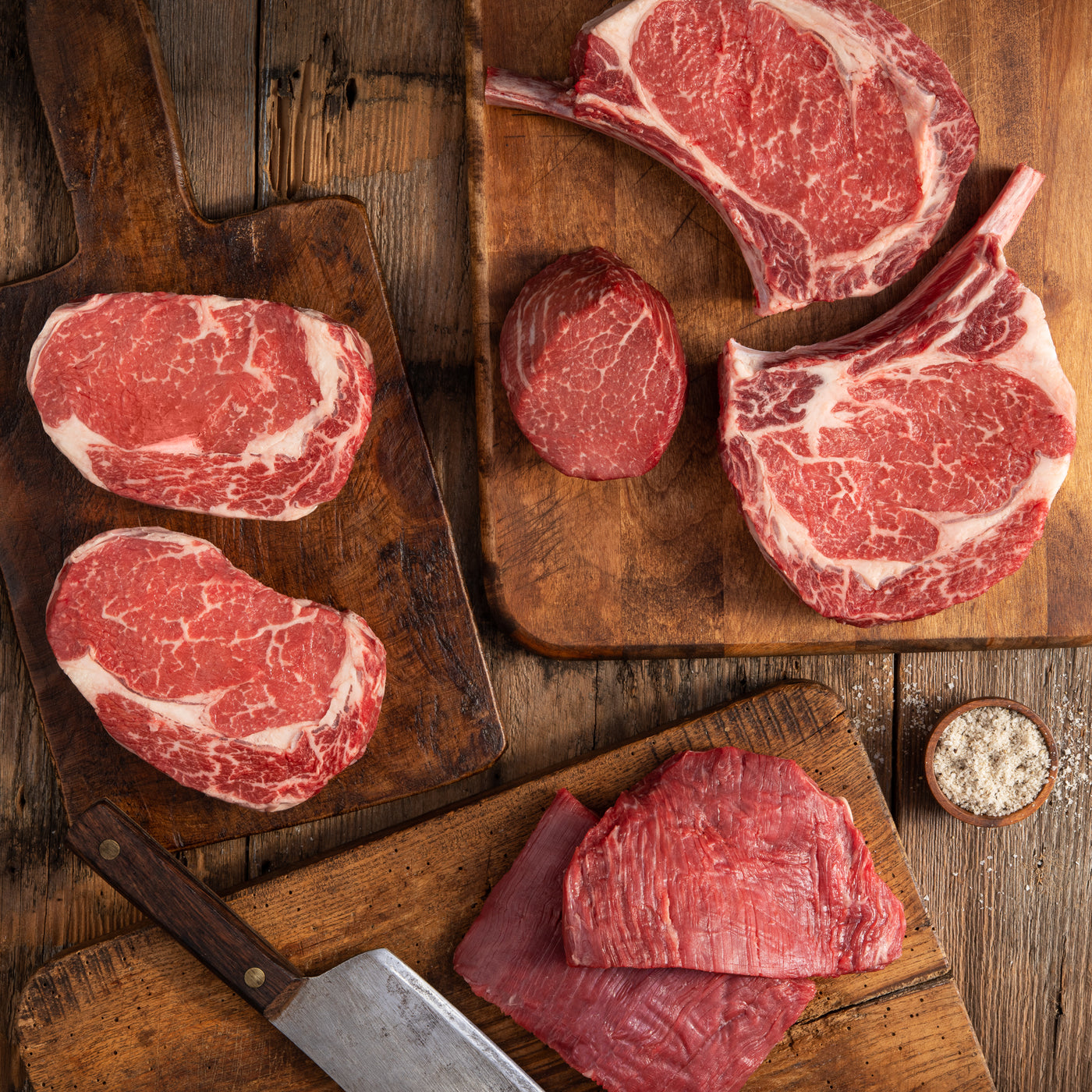 rancher collection steak bundle on cutting board with butcher knife