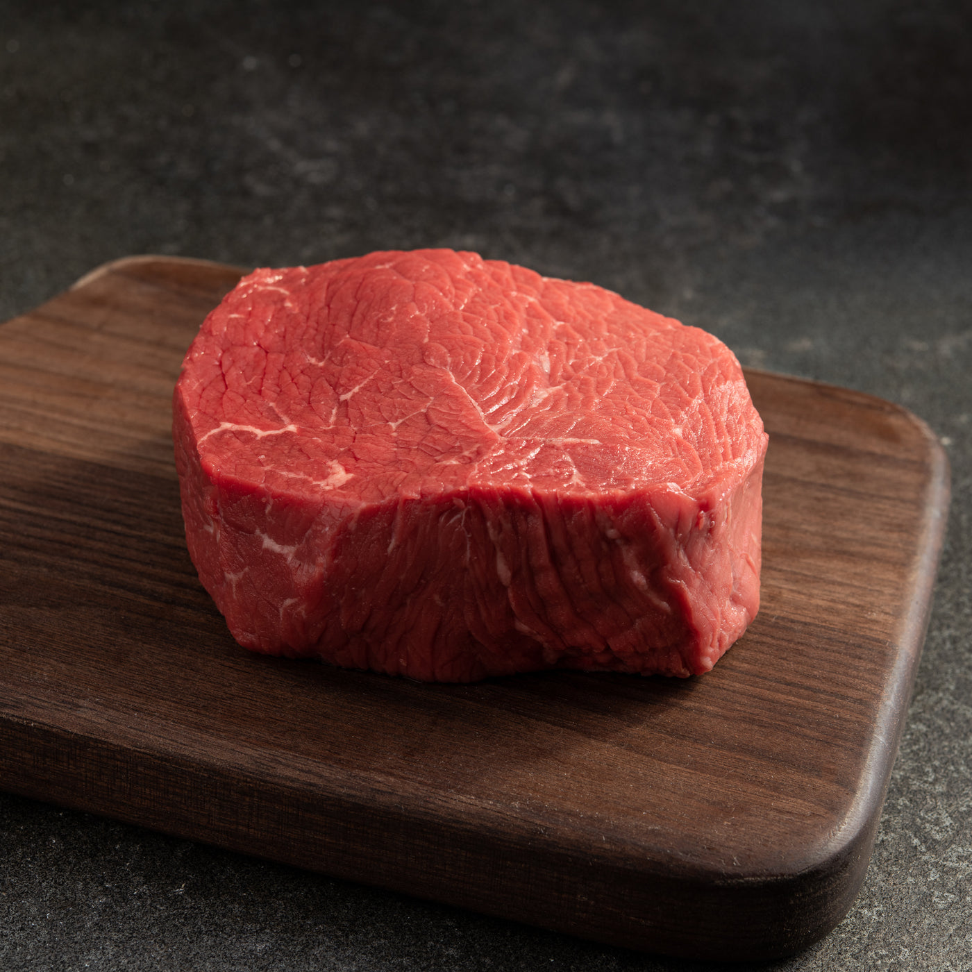 usda prime top sirloin steak on wooden cutting board