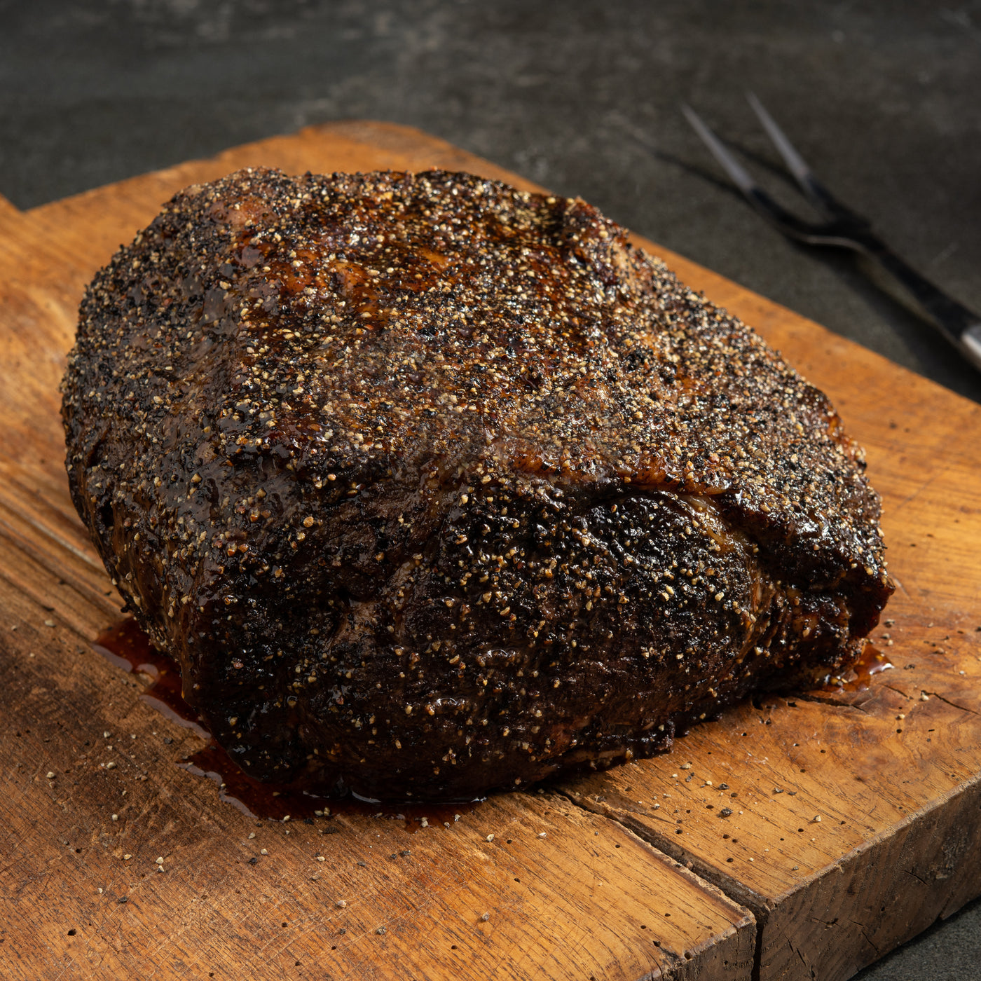pre-cooked smoked prime rib on cutting board with seasoning