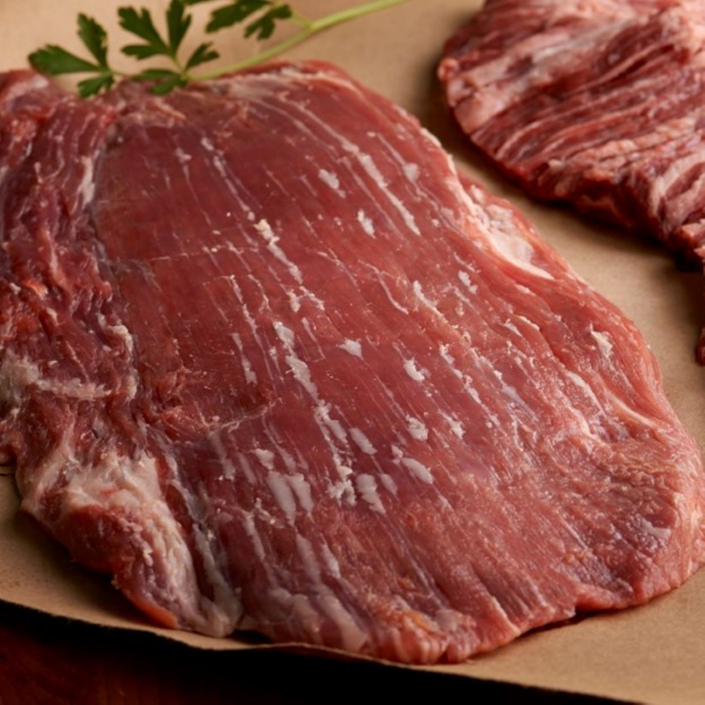 usda choice angus beef flank steak on parchment paper close up view