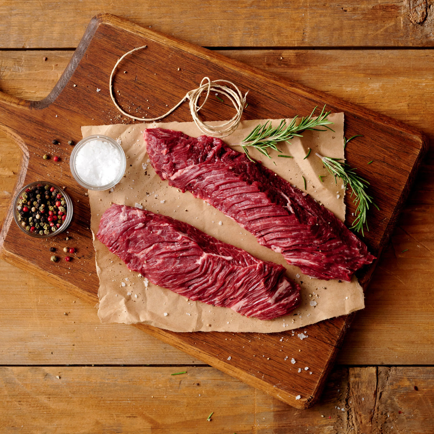 choice hanger and skirt steak butcher cut with seasoning on wooden cutting board