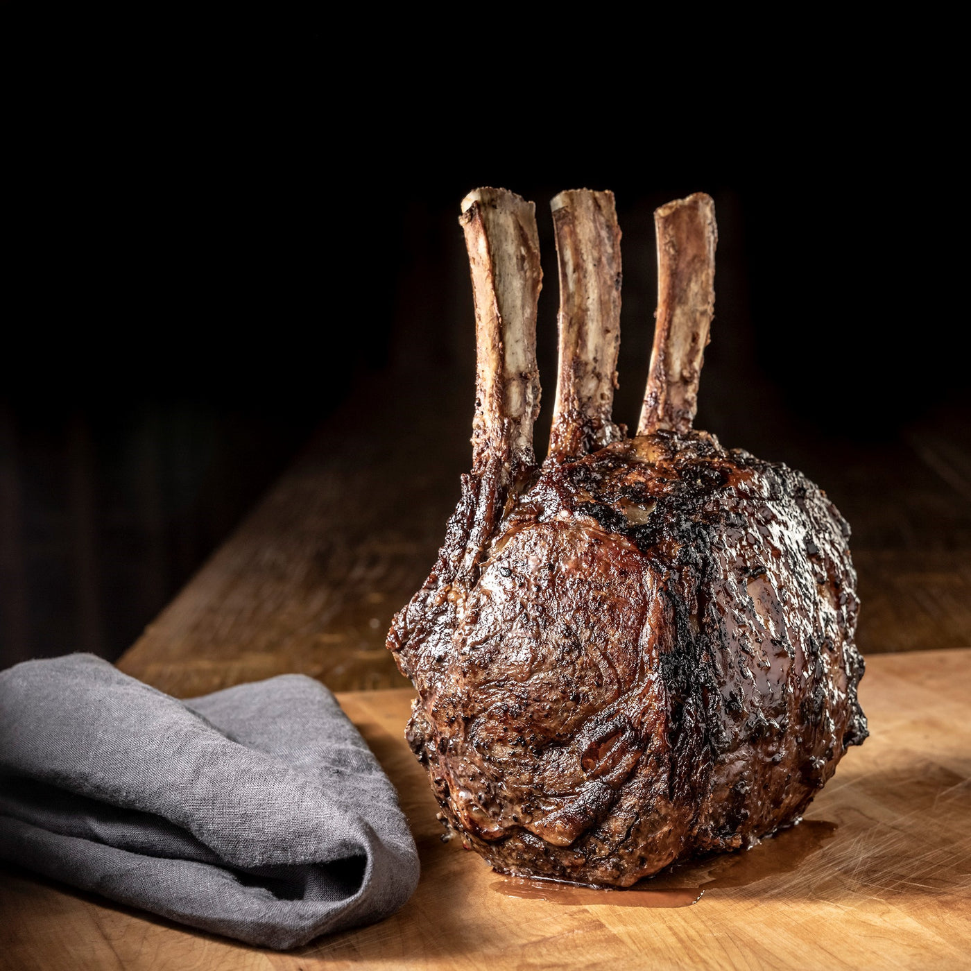 cooked tomahawk prime rib roast bone in with seasoning and rub