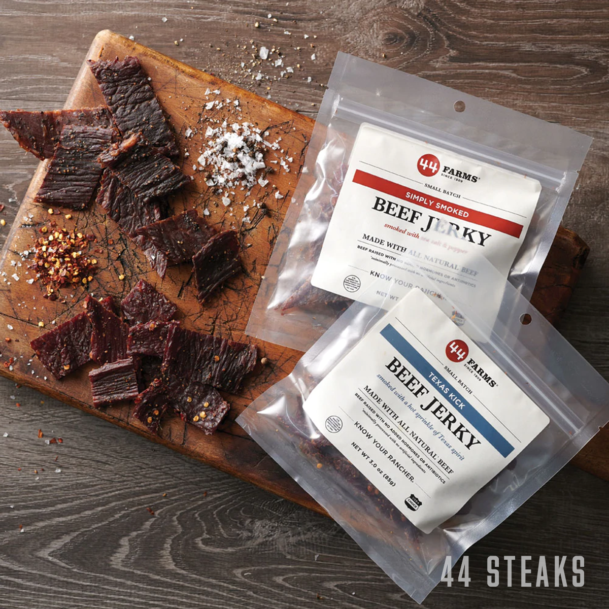 44 farm beef jerky combo pack bundles on cutting board with seasoning
